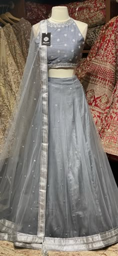 Dolphin grey sliver sequins butti lehenga teamed with high neck sliver zari and sequence embroidered blouse and net dupatta. Fabric: Net and Satin Silk This outfit can be customized in multiple colors and specific to client measurements. 120 days of production time is required and are for bulk orders only! Orders are processed in store only! Final fittings/alterations not included. Minimum Order Quantity- 4 pieces Plane Lehenga Design, Silver Traditional Wear With Resham Embroidery For Diwali, Diwali Silver Traditional Wear With Resham Embroidery, Silver Anarkali Set With Zari Work For Eid, Silver Anarkali Sharara Unstitched, Silver Sharara With Zari Work For Festivals, Silver Raw Silk Set For Wedding, Silver Zari Work Sets For Diwali, Silver Sets With Zari Work For Diwali