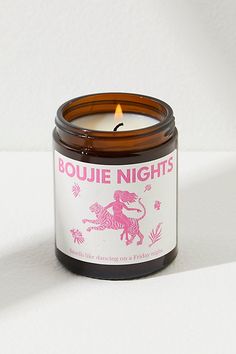 a candle that is sitting on top of a white surface with the words bougie nights printed on it