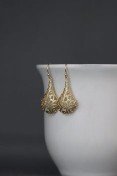 "Bold and detailed matte gold vermeil filigree charms simply dangle from gold vermeil balled earwires. These dramatic cut out charm earrings complete any outfit for daytime or evening. Gold charms: 19x32mm Total length of earrings: 1 3/4\" All gold is 18k gold vermeil. As the owner, maker, designer, and curator of this shop, I take great pride in providing you with jewelry that you will love to wear everyday, for special occasions, and for many years to come. Please read my Shop Policies which c Teardrop-shaped Gold Plated Filigree Jewelry, Gold Plated Filigree Teardrop Jewelry, Classic Pierced Chandelier Earrings As Gift, Elegant Brass Jewelry With Intricate Design, Gold Teardrop Earrings With Intricate Design, Classic Gold Earrings With Elegant Design, Gold Teardrop Earrings With Intricate Design As Gift, Classic Chandelier Earrings Gift, Elegant Teardrop Earrings With French Hook For Gift