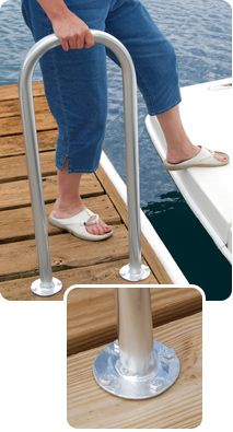 a woman is standing on the edge of a boat with her foot in the water