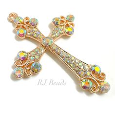 a gold colored cross with multicolored stones