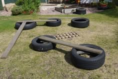 there are tires and wooden planks in the yard