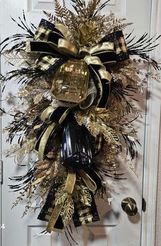 a black and gold wreath hanging on the front door