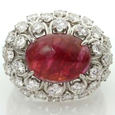 For Sale on 1stdibs - This captivating ring from David Webb features an open-design dome crown prong-set with an oval 11.0mm x 15.0mm cabochon ruby and surrounded by 36 sparkling Luxury Ruby Cabochon Diamond Ring, Luxury Ruby And Diamond Oval Cabochon Ring, Luxury Oval Cabochon Ruby Ring, Luxury Ruby Ring With Oval Cabochon, Luxury Ruby Ring With Oval Cabochon Diamond, Formal Ruby Ring With Diamond And Oval Cabochon Shape, Formal Oval Cabochon Ruby Ring With Diamond, Oval Cabochon Ruby Ring With Diamonds, Gem Hunting