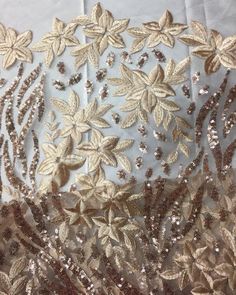 gold sequins and leaves on sheer fabric with beaded edges, closeup