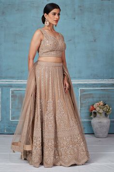 Turn heads at weddings and special occasions in this stunning beige embroidered designer lehenga with dupatta. Traditional Drape Lehenga With Intricate Embroidery, Traditional Drape Beige Embroidered Lehenga, Traditional Beige Lehenga With Intricate Embroidery, Beige Lehenga With Intricate Embroidery, Beige Semi-stitched Choli With Traditional Drape, Embellished Beige Sharara For Reception, Semi-stitched Beige Choli With Intricate Embroidery, Beige Semi-stitched Gown For Reception, Beige Semi-stitched Choli With Intricate Embroidery