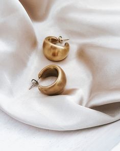 Our Enoch Matte Gold Earrings are the perfect touch of luxe to transform any look. Exquisitely crafted in a matte gold tone, these statement earrings add a sophisticated and unique element to any ensemble. Crafted with waterproof material, these earrings are perfect for any occasion - rain or shine! Brushed, Matte Gold finish 2 sizes to choose from Waterproof Tarnish resistant 18K Gold plated stainless steel Hypoallergenic Matte Gold Plated Minimalist Earrings, Matte Gold Minimalist Metal Earrings, Matte Gold Minimalist Earrings, Chic Gold-tone Brass Earrings, Chic Gold Brass Earrings, Chic Brass Hoop Earrings For Formal Occasions, Elegant Bronze Metal Hoop Earrings, Chic Gold-tone Brass Hoop Earrings, Modern Matte Gold Brass Hoop Earrings