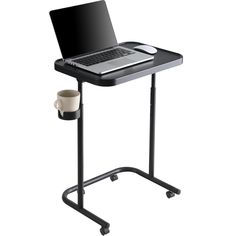 a laptop computer sitting on top of a black stand next to a cup and coffee mug