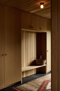 a room with wooden cabinets and a rug on the floor