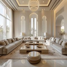 an elegant living room with white couches and large windows