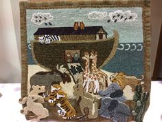 an animal themed rug is on display in front of a wall with other animals and a boat