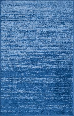 a blue area rug that is very soft and has an uneven pattern on the surface