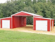 a red and white garage with two doors on the side, in front of trees