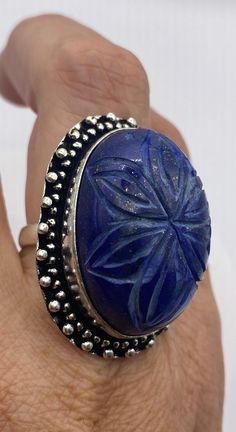 Large genuine blue Lapis Lazuli vintage ring Flower hand carved Low content silver not sterling. Size 8 Can be re sized. My jeweler charges $20 All rings are shipped in a nice gift box. Check out our over a THOUSAND great reviews Engraving is $4 per letter and is not always perfect depending on the piece. It can take a few days if the jeweler is busy. This is payable to Paypal Judithsltd@gmail.com Blue Etched Round Jewelry, Blue Round Etched Jewelry, Artisan Carved Ring As A Gift, Artisan Carved Ring As Gift, Blue Gemstone Flower Ring Gift, Artisan Carved Rings As Gifts, Artisan Carved Rings For Gift, Unique Carved Rings As Gifts, Artisan Carved Blue Jewelry