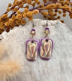 Elevate your accessory game with our stunning Heartfelt Charm Dangle Earrings! Handcrafted with care, these boho-inspired earrings feature a striking rectangle design in vibrant purple porcelain ceramic, elegantly accented by dazzling Czech glass beads. The lovely heart motif adds a touch of pleasing poise to any outfit. Perfect for making a statement, these earrings are a must-have for your collection.  Grab your set today and showcase your unique style! Fast and Free shipping. Rectangle Design, Heart Motif, Handmade Porcelain, Vibrant Purple, Boho Stil, Porcelain Ceramics, Czech Glass Beads, Czech Glass, Earrings Handmade