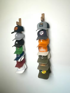 several hats are hanging up on the wall