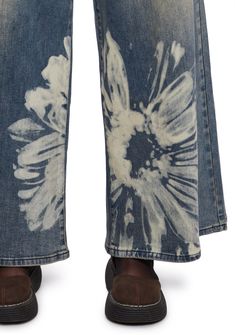 These jeans have a soft washed denim construction, a bleached floral pattern on the front and back, a wide leg silhouette, front and back pockets, and a front zipper and button closure. Current Mood Clothing, Get A Life, The Terrace, Current Mood, Washed Denim, Dolls Kill, Exclusive Collection, Denim Wash, Wide Leg Jeans