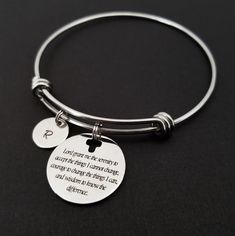 "Serenity Prayer Bracelet Personalized Initial Bangle Bracelet! A round charm printed with Serenity Prayer beginning with \"Lord grant me the serenity\" on a stainless steel expandable bangle bracelet makes the perfect gift for you or a loved one. God, grant me the serenity to accept the things I cannot change, Courage to change the things I can, And wisdom to know the difference. The religious bracelet charm is made from stainless steel and measures 24 mm by 24 mm. The bible verse bracelet is h Hypoallergenic Round Friendship Bracelets, Inspirational Friendship Bracelet Jewelry, Spiritual Round Stainless Steel Bracelets, Stainless Steel Beaded Bangle Bracelets As Gift, Stainless Steel Bangle Beaded Bracelets For Gift, Meaningful Adjustable Bangle Bracelet, Adjustable Round Bracelet As Best Friend Gift, Stainless Steel Beaded Bracelets For Gifts, Round Metal Bracelets For Gifts