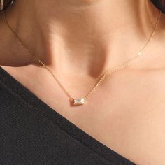 Elevate your style with our Minimal Baguette Necklace. The sleek baguette-cut pendant, suspended from a delicate gold chain, exudes timeless elegance. With its minimalist design and fine craftsmanship, this necklace effortlessly transitions from day to night, making it a versatile and refined addition to your collection. Whether worn solo or layered, it's a symbol of enduring beauty and impeccable taste. - Made in 14k solid gold - Decorated with handset white cubic zirconia stone on 14k solid go Minimal Gold Pendant Design, Sleek Gold Chain, Minimal Chain Necklace, Bagette Necklace, Minimal Pendant Necklace, Elegant Gold Necklace With Baguette Shape, Elegant Gold Baguette Necklace, Chic Rectangular Necklaces For Formal Occasions, Elegant Evening Necklaces With Baguette Cut