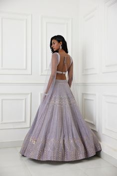 Lilac organza lehenga with glass beads, zardozi and pearl embellishments paired with raw silk embroidered blouse with long tulle cape sleeve.From Chamee and Palak's The Romantics collection.DELIVERY TIMEPlease allow 8-12 weeks for your outfit to arrive.FABRIC DETAILSOrganza, Silk, NetProfessional cleaning only. Designer Dresses With Intricate Embroidery And Cape Sleeves, Anarkali Gown With Cape Sleeves And Resham Embroidery, Anarkali Organza Dress With Cape Sleeves, Anarkali Gown With Cape Sleeves For Reception, Organza Choli With Zari Work And Cape Sleeves, Organza Choli With Cape Sleeves And Zari Work, Designer Anarkali Lehenga With Cape Sleeves, Anarkali Lehenga With Zari Work And Cape Sleeves, Fitted Lehenga With Resham Embroidery And Cape Sleeves