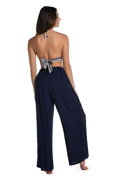 These palazzo pants get their boho-inspired style from crocheted side panels. Perfect for pulling on post dip, you can wear them as a swimsuit cover-up but they also look fabulous with a tank or cami for an effortlessly chic look. A gently elasticized waist offers a comfortable fit. [split] Details Palazzo-style beach pants Elasticized waistband Wide legs for a flowy fit Lightweight rayon fabric Fabric 100% Rayon Bohemian Stretch Bottoms For Beach, Bohemian Stretch Bottoms For Vacation, Bohemian Stretch Pants For Vacation, Bohemian Harem Pants For Beach Season, High Waist Pants With Lace Trim For Summer, Sleeveless Summer Beach Cover-up Bottoms, Bohemian High Waist Harem Pants For Beach, Bohemian Tie-side Bottoms For Beach Cover-up, Sleeveless Bohemian Beach Cover-up Bottoms