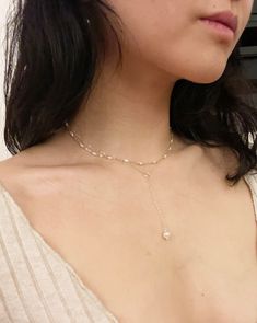 "A lariat choker with a single drop of designer grade, freshwater pearl. I love the touch of roped ring on this minimal piece. Every component is so delicate and elegant on the decolletage.  Around neck length is 15\", drop length is  2 5/8\". Chain: solid sterling silver. Jump Rings: sterling silver plated. Clasp: platinum plated stainless steel. Pearl: genuine fresh water pearl *please note that size and shape may vary due to the nature of genuine pearls* ~Thank you for visiting my humble shop! All items are handmade with care and love. Please feel free to message me with any questions or comments! I hope you like my pieces~ ~all items are hand made and unique, therefore the components may have some variance.  Each piece will be made with utmost care, but they are delicate so please be c Delicate Pearl Lariat Necklace With Pendant, Pearl Dangle Lariat Necklace, Adjustable Pearl Pendant Lariat Necklace, Pearl Lariat Necklace With Clavicle Chain, Adjustable Pearl Lariat Drop Necklace, Adjustable Pearl Lariat Necklace With Pearl Charm, Adjustable Dangle Lariat Necklace With Pearl Pendant, Adjustable Lariat Necklace With Pearl Pendant, Dainty Adjustable Lariat Necklace With Pearl Pendant