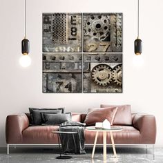 a living room with a couch and two pictures on the wall above it that have gears in them