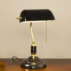 a desk lamp sitting on top of a wooden table