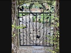 an iron gate that has birds on it