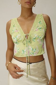 Add a pop of color to your summer wardrobe with the Dreamer Top Green. Featuring a delicate pink floral pattern and tie detail in the center, this top is perfect for a date night or night out. Pair it with the matching Dreamer Mini Skirt Green for a... Peridot Green, Pink Floral Pattern, Floral Tank Top, Purple Top, Linen Trousers, Floral Tank, Dress Hats, Scalloped Lace, Green Skirt