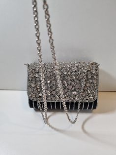 A stunning clutch purse in a beautiful black. A statement piece that will make any outfit. Photos do not do it justice. Elegant Silver Clutch With Chain Strap, Chic Evening Bag With Bling For Night Out, Chic Black Evening Bag With Rhinestones, Elegant Evening Bag With Bling, Elegant Clutch With Bling For Events, Elegant Bling Clutch For Events, Elegant Event Clutch With Bling, Embellished Black Rectangular Clutch, Embellished Black Clutch Bag