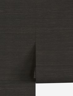 the side of a black wallpaper with vertical lines on it and a white strip at the end