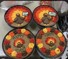 four cakes decorated to look like turkeys with happy thanksgiving written on them