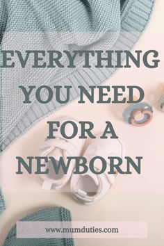 a pair of baby shoes sitting on top of a white table next to a blue blanket