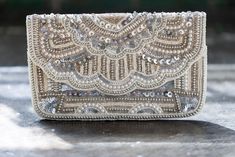 Embellished Clutch For Festive Occasions, Luxury Beaded Evening Bag For Reception, Glamorous Clutch With Pearl Embroidery, Glamorous Hand-embellished Evening Bag For Events, Festive Beaded Evening Bag For Reception, Festive Evening Clutch With Sequins, Glamorous Hand Embellished Evening Bag For Events, Festive Embellished Evening Clutch Bag, Glamorous Hand Embellished Evening Bag