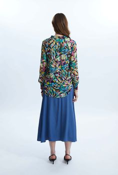 This chic yet bold printed blouse is a James Lakeland staple piece. Featuring its classic mandarin collar and short V-neck opening, long sleeves and elasticated cuffs. This chiffon blouse, lined in the same printed fabric has a slight sheer to it whilst being modest, with its shorter front and longer back panel which can be tucked-in or out.     Made in India 100% Polyester Machine Wash 30°C, Do not bleach, Do Not Tumble Dry. Chic Multicolor Viscose Blouse, Green Printed Blouse For Daywear, Multicolor Floral Print Viscose Blouse, Spring Multicolor Viscose Blouse, Multicolor Abstract Print Tops For Work, Chic Multicolor Tops For Daywear, Multicolor Relaxed Fit Blouse For Fall, Spring Workwear Blouse With Abstract Print, Spring Abstract Print Blouse For Work