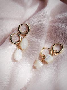 The Lei Hoops reflect Hawaii's natural abundance and beauty. These small gold mother of pearl and gold huggie hoop earrings feature darling carved seashell flower charms reminiscent of Hawai'i's flower leis. These pretty gold hoops are perfect solo or teamed with our some huggie hoops.Handmade on Maui, Hawaii. ✦ Choose from two flower styles: Tulip or Pikake ✦✦ DETAILS ✦✧ Name: Lei (LAEE) - garland.✧ 18kt Gold Vermeil.✧ 25mm & 29mm Drop Length✧ 12mm hoop outer diameter, 9mm inner diameter, & 2.5 Mother Of Pearl Single Earring For Gift, Mother Of Pearl Single Earring As A Gift, Single Mother Of Pearl Earring For Gift, Single Mother Of Pearl Earring As A Gift, White Hypoallergenic Huggie Jewelry, Hypoallergenic White Huggie Jewelry, Shell-shaped Pearl Charm Earrings As Gift, Shell-shaped Single Earring For Gift, White Teardrop Huggie Earrings Hypoallergenic