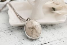 "I love these charming tiny treasures of the sea! Are you an ocean lover? Display your love of the sea with this little treasure!  This fossilized sand dollar / sea biscuit necklace is framed in a hand made sterling silver bezel and hangs from a sterling chain. Pendant size will vary but measure approximately 1\". ✽ Sterling Silver Setting ✽ Sterling Chain 16\"- 18\"  ✽ Real Sand Dollar ✽ Beautifully packaged ready for gift giving This necklace is made to order. The fossil may be slightly differ Ocean-inspired Jewelry With Starfish Charm As Gift, Ocean-inspired Jewelry With Starfish Charm For Gift, Starfish Charm Pendant Jewelry Gift, Starfish Charm Pendant Jewelry For Gift, Bohemian Starfish Necklace For Gifts, Bohemian Starfish Necklace For Gift, Ocean-inspired Round Jewelry With Starfish Charm, Personalized Ocean-inspired Jewelry Gift, Dainty Starfish Charm Jewelry Gift