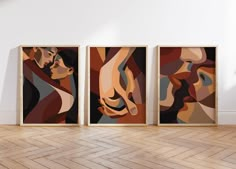 three abstract paintings hang on the wall in an empty room with parquet flooring