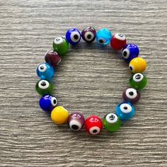 Lampwork Handblown Glass Evil Eye Bracelet. Multicolored. Handmade In The Usa And Never Worn. One Size Fits All. Vibrant Red Bracelets For Gift, Multicolor Evil Eye Round Bracelets, Multicolor Round Evil Eye Bracelets, Casual Multicolor Beaded Evil Eye Bracelet, Multicolor Evil Eye Bracelets, Multicolor Evil Eye Bracelet Gift, Vibrant Multicolor Bracelets As A Gift, Vibrant Multicolor Bracelets As Gift, Vibrant Multicolor Bracelets For Gift