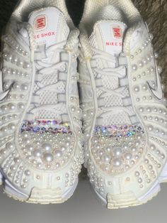 Custom Embellished Women's Nike Shox TL Running Shoes Sz 36 5.5 Pearls & Swarovski AB Rhinestones Sneakers Reg Price 350 - Now 50% Off SALE  Shoes are in EXCELLENT Like New Condition Custom PEARL & Swarovski AB Rhinestones Embellished | One of a Kind - Excellent Pre-owned condition - LIKE NEW EMBELLISHMENT UPDATED: TOES COVERED with Swarovski AB Crystals & Pearls ABSORBS IMPACT!  Lots of testers agree that the Nike Shox TL sneakers are comfortable on foot, even for standing and walking all day long. Changed from a high-grade plastic (similar to that used in car bumpers) to a polyurethane-based material, but it's still extremely durable. Made with lightweight fabric uppers in place of heavier leather  I always received multiple compliments every time I wore them!  They are gorgeous and head Elegant Party Sneakers With Bling, Pearl Nike Shoes, Elegant Party Sneakers With Rhinestones, Bejeweled Nike Shoes, Pearl Nike Air Force, White Custom Rhinestone Sneakers For Streetwear, Nike Shox White, Womens Nike Shox Shoes, Nike Shox For Women