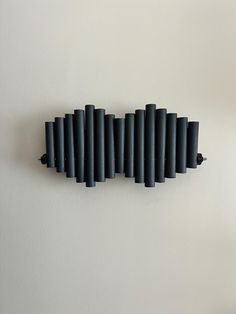 the wall is made up of black pipes