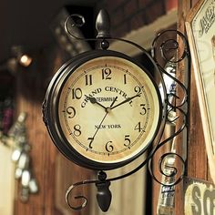 an old fashioned clock hanging from the side of a building