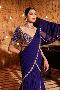 Indulge in elegance with this gorgeous purple drape sari in georgette, featuring exquisite embroidery detailing at the bottom and on the palla. The fully embroidered blouse adds a touch of sophistication to the ensemble. Padded for comfort, the blouse is designed with a side zip closure for a seamless fit. Elevate your style with this meticulously crafted outfit that exudes grace and timeless beauty. Drape Sari, Purple Sari, Purple Drapes, Wedding Dress Code, Sarees South Indian, Bridal Sarees South Indian, Saree Georgette, Fairy Folk, Indian Bride Outfits