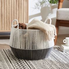 a basket that has some blankets in it