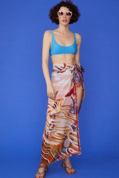 Wrap yourself in luxury with our Multi Tie-Waist Sarong, a versatile piece that exudes tropical elegance. Crafted from a sumptuous blend of cashmere, silk, and cotton, this sarong offers an incredibly soft touch while maintaining a lightweight, airy feel. The vibrant tropical print transports you to paradise, while the contrast hem adds a chic, defined edge. Designed with a flexible tie-waist, this one-size-fits-all sarong is perfect for beach days, poolside lounging, or adding a stylish layer t Moroccan Oil Hair, Cute Coverups, Holiday Vibes, Stylish Skirts, Pool Side, Long Sleeve Outerwear, Medical Aesthetic, Womens Cashmere, Moroccan Oil