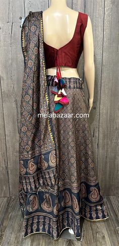 Ajrakh printed chaniya choli set for Navratri/ Garba. Twirl around in this digitally printed Ajrakh skirt on art silk. Skirt: Fits waist upto 38 inches, length 42 inches  Blouse: Size 36 -37 inches, fabric for short sleeves included  Due to seasonal nature of this product, it cannot be returned. Color : Blue Festive Transitional Anarkali Set With Kalamkari Print, Festive Unstitched Anarkali Set With Kalamkari Print, Unstitched Kalamkari Anarkali Set For Navratri, Transitional Kalamkari Print Sets For Puja, Anarkali Multicolor Tussar Silk Choli, Traditional Drape Sharara With Block Print For Festivals, Traditional Drape Block Print Sharara For Festivals, Traditional Sharara With Kalamkari Print For Festive, Traditional Multicolor Tussar Silk Choli