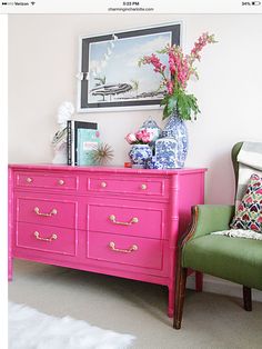 a pink dresser with flowers on top and an image of a green chair next to it