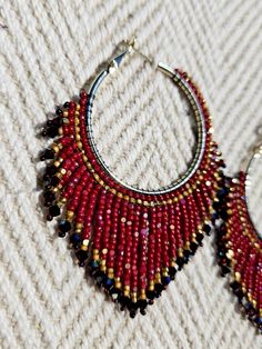 Colors - Dark red / Retro Gold Unique Handwoven Beaded Hoop Earrings with Swarovski Crystals - These elegant 35mm thick coated gold plated (nickel & lead free) hoop earrings are a true statement piece, handwoven with two-sided cut Charlotte beads that shimmer from every angle. The design is elevated with sparkling Swarovski bicone stones, creating a luxurious and eye-catching finish. Measuring 2.76 inches in length and 2.35 inches in width, these earrings are perfect for making a bold and elegant impression. They are a stunning addition to any jewelry collection. Due to their intricate craftsmanship, please handle them with care to maintain their beauty. * Please note that colors may vary slightly due to different monitor settings. Handmade Red Beaded Hoop Earrings, Red Round Beaded Earrings For Festive Occasions, Red Colorful Beads Hoop Earrings, Red Beaded Round Hoop Earrings, Red Hoop Earrings With Colorful Beads For Jewelry Making, Red Hoop Earrings With Colorful Beads, Handmade Hoop Earrings For Celebration, Red Round Beaded Party Earrings, Red Faceted Beads Earrings For Festive Occasions