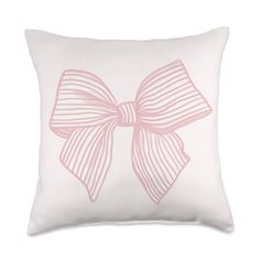 a white pillow with a pink bow on it